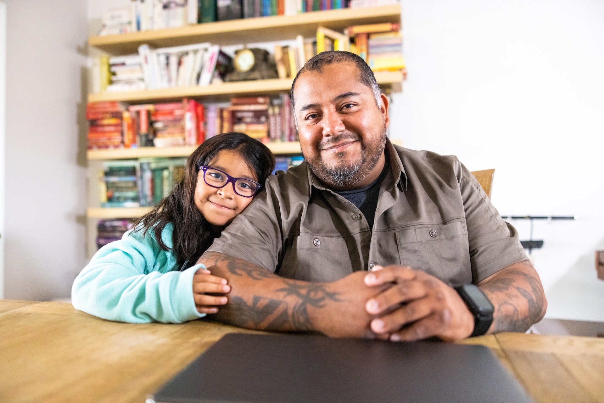 A Hispanic American veteran double amputee on a laptop